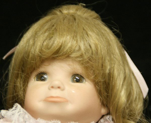 Crying Full Body Porcelain Little Girl Doll: This is a full body porcelain doll with movable arms, legs and head. Her cheeks hold tears from her crying and now she has a big lower lip pout on her face. She is wearing a cute little pink dress wit