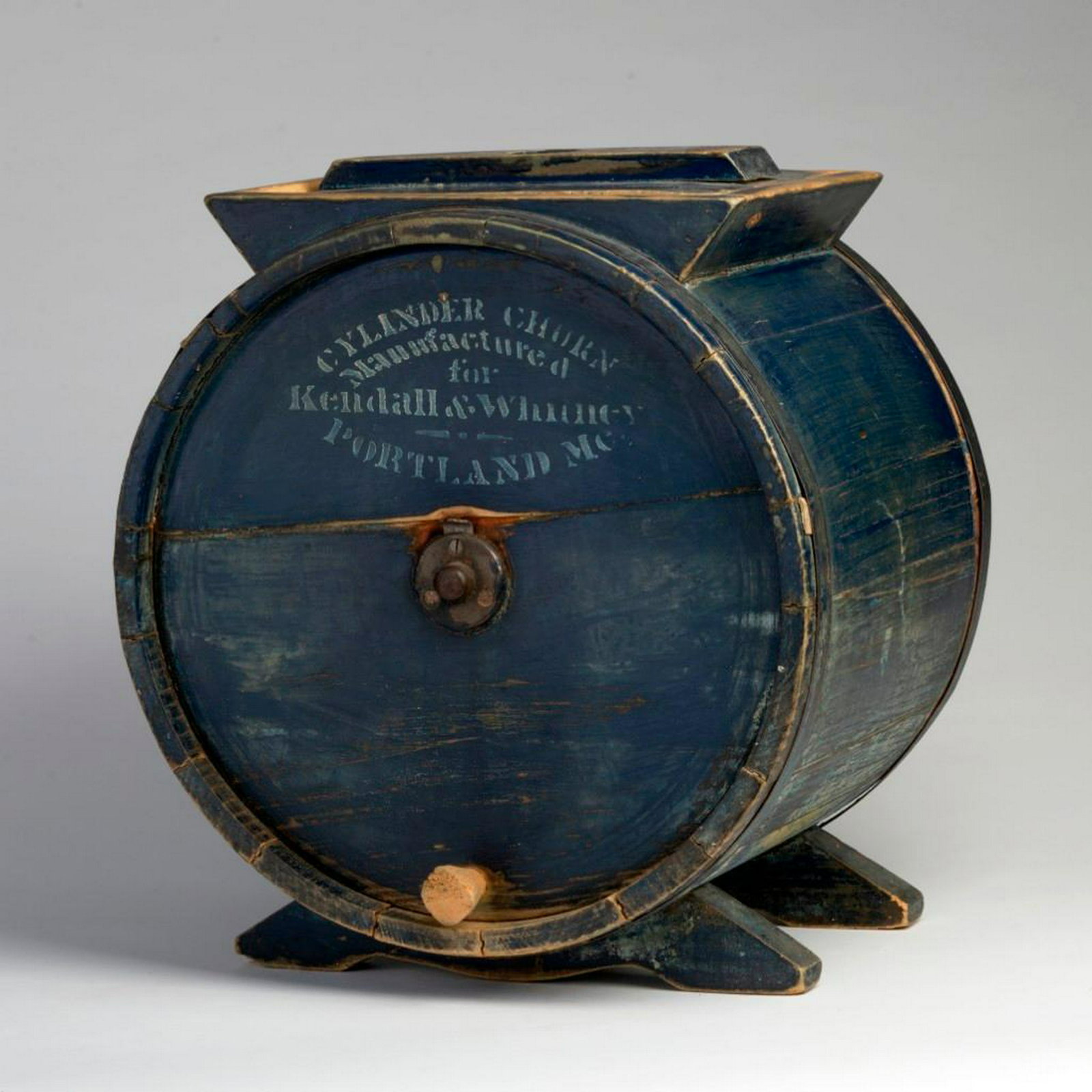 Butter Churn in Blue Paint: Marked "Cylinder Churn / Manufactured for / Kendall & Whitney / Portland, ME." Height 16 1/2 inches, width 15 inches, depth 11 inches.