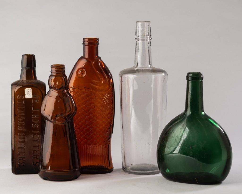 Five Glass Bottles.: Including Dr. J. Hostetter's Stomach Bitters, height 9 inches, Aunt Jemima, fish bottle, a clear blown molded bottle, and a green glass flask.