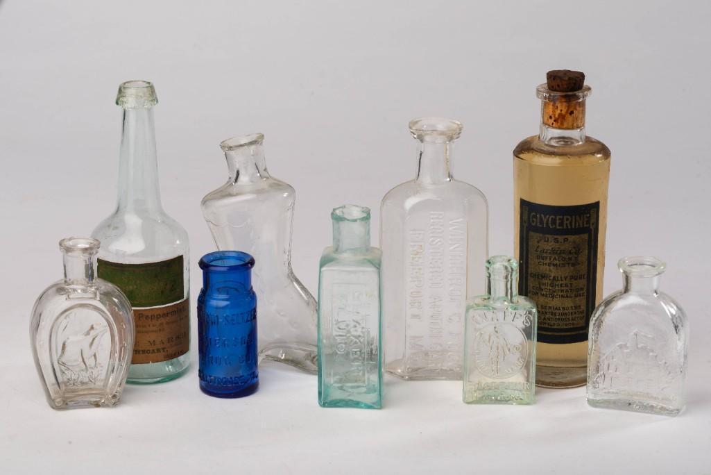 Nine Small Bottles.: Including a horseshoe shaped bottle with frog, George Marsh Essence of Peppermint with original paper label, blue Emerson Drug Co. Bromo-Seltzer, boot form bottle, Shaker Fluid / Extract Valerian, Win