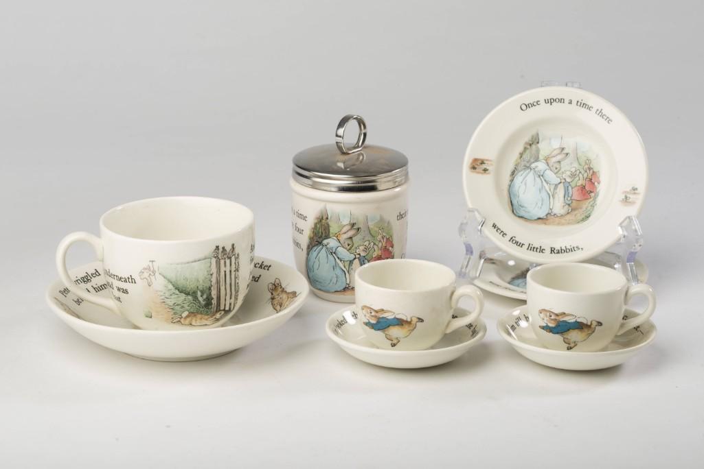 Set of Wedgewood Peter Rabbit Wares.: Including a teacup and saucer, two miniature teacups and saucers, two small plates, and a lidded canister.