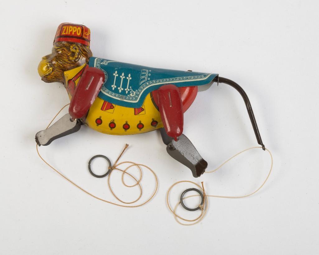 Marx Tin Zippo Monkey.: Lithograph decorated body, in working condition. Length overall 10 inches.