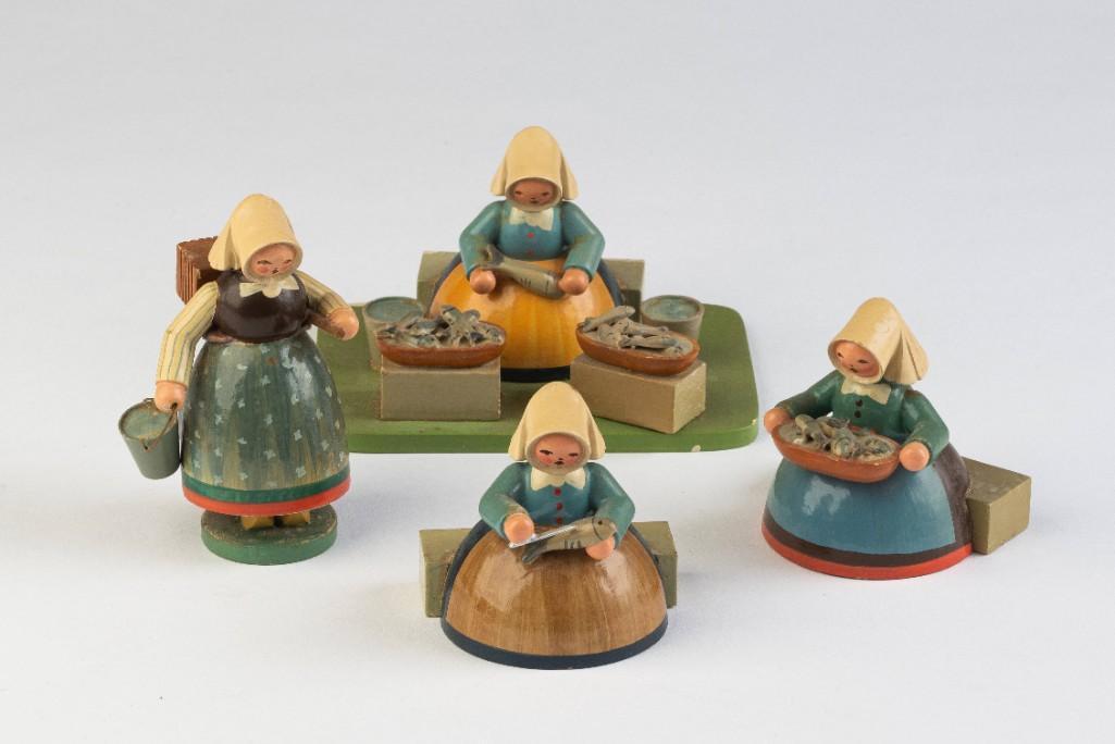 Four East German Wood Carvings.: Depicting women processing fish. Height of tallest 3 3/4 inches.