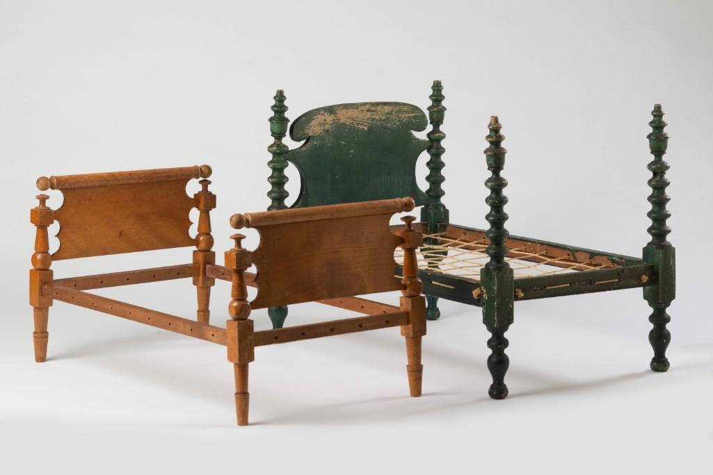 Two Doll's Beds.: Including one in green paint, height 12 1/2 inches, length 17 inches, depth 11 1/4 inches, and one in natural finish, height 9 inches.