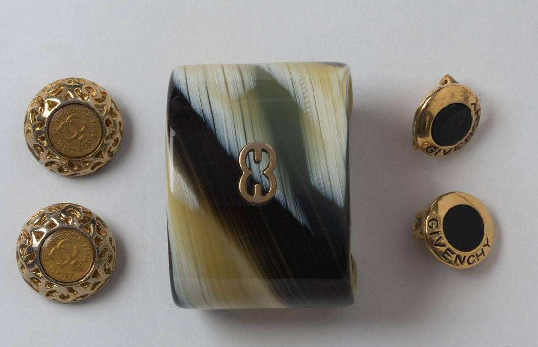 Group of Designer Costume Jewelry.: Including gold Chanel clip on earings, Escada cuff bracelet, and gold Givenchy clip on earrings. Items may be previewed at our Freeport, Maine gallery prior to the close of the auction. Call 207-370-4