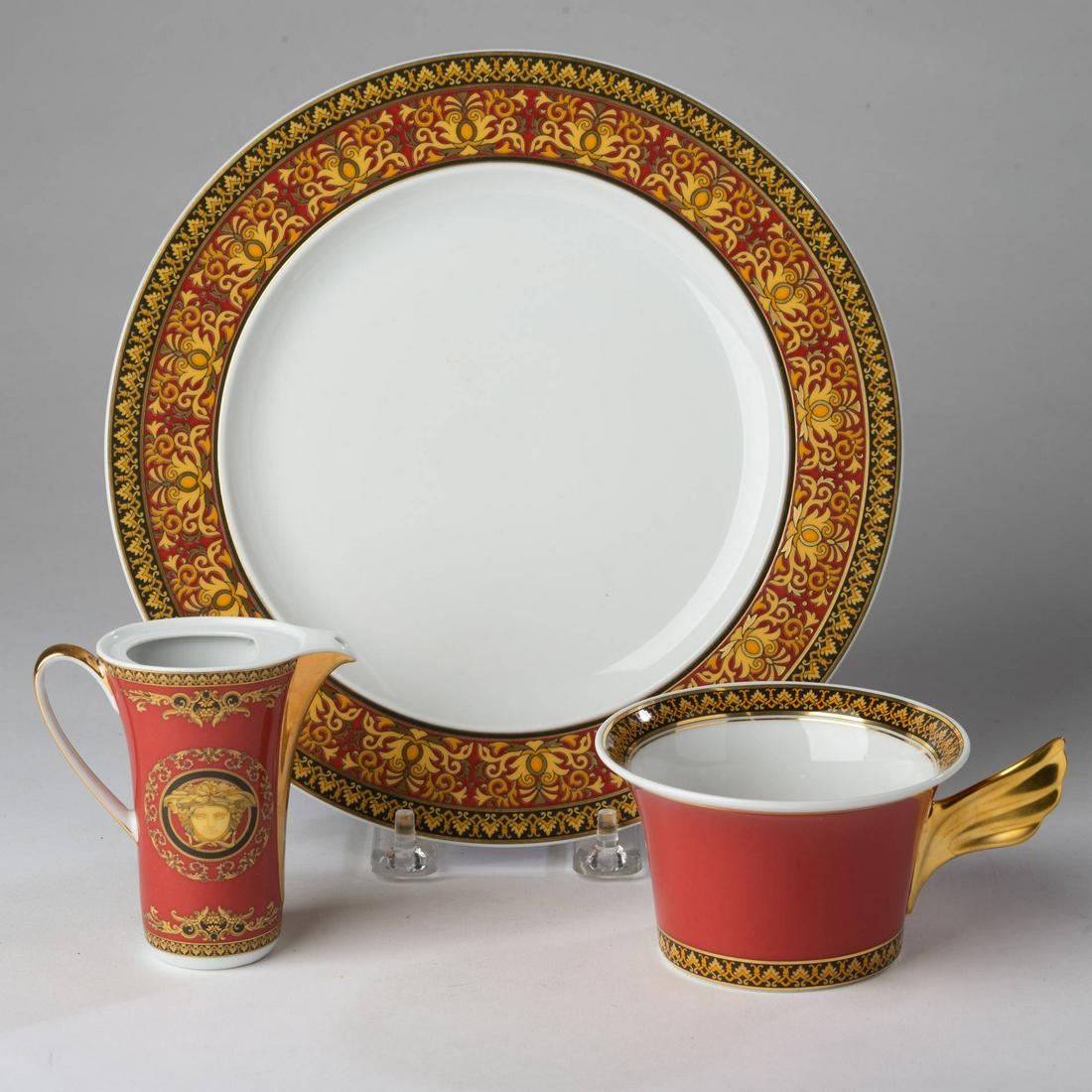 Threee Rosenthal Versace Medusa Wares.: Plate, diameter 8 3/4 inches. Teacup, height 2 1/4 inches. Creamer, missing cover, height 3 1/2 inches. Items may be previewed at our Freeport, Maine gallery prior to the close of the auction. Call 20