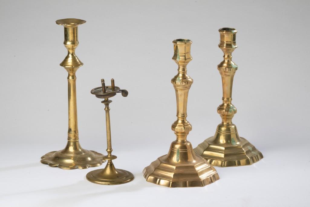 Three Brass Candlesticks.: Including a pair, height 10 inches, drilled for electricity, and a Queen Anne style example, 10 1/2 inches. Together with a Fleming's lighting device.