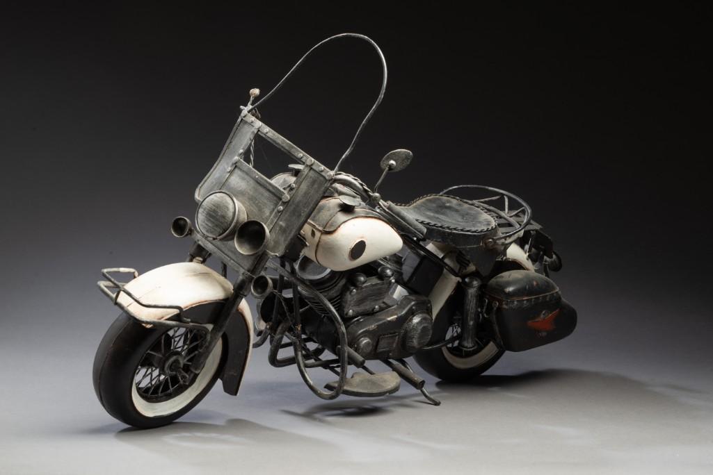 Folk Art Motorcycle Sculpture.: Polychrome painted tin, length 18 inches, height 11 1/2 inches.