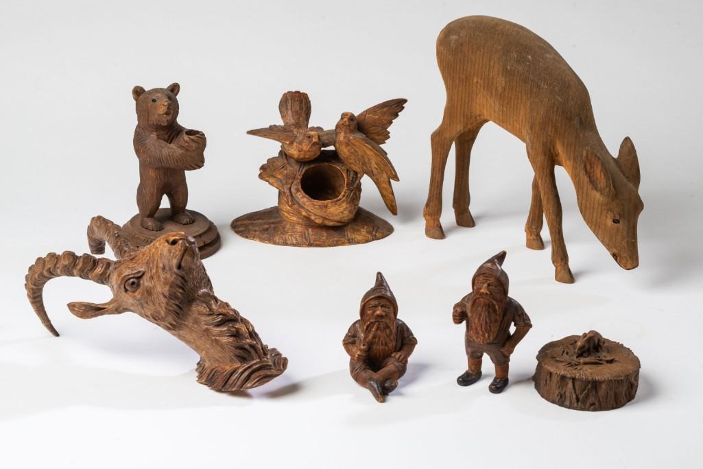 Group of Carved Wooden Figures.: Including a Black Forest bear, height 5 inches, bird inkwell, height 4 inches, grazing deer, height 7 inches, gazelle head, height 7 1/2 inches, two gnomes, heights 3 1/2 and 2 3/4 inches, and a conta