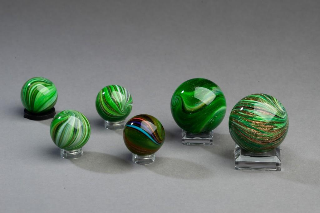 Six Hamon Marbles.: Contemporary marbles by Robert Hamon, circa 1995-99. Green solid core onion skin type with lutz, diameters 1 1/16 to 1 5/8 inches.