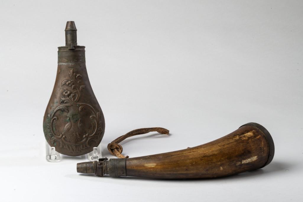 Powderhorn and a Shot Flask.: The shot flask, of copper construction and decorated with grouse, length 7 inches. The powderhorn, with working mechanism, length 10 1/4 inches.
