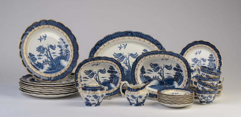 Booths Real Old Willow Part Dinner Service.: Comprising eight 1 1/2 inch dinner plates, eight 7 3/4 inch luncheon plates, eight teacups and saucers, sugar bowl, creamer, 11 x 14 inch platter, 8 1/2 inch vegetable dish, and a 1 inch vegetable dis