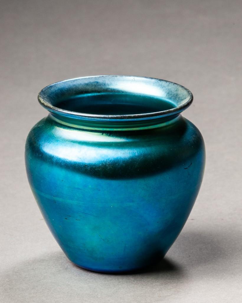 Small Steuben Iridescent Vase.: Height 2 1/2 inches. Signed on base. Detailed condition reports are available upon request. Due to the current stay at home order, in-person preview will not be available until May 1 Items may be pick
