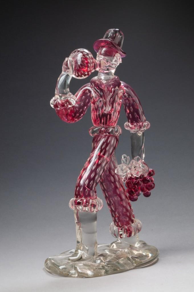 Salviati Murano Large Glass Figure of a Winemaker.: Depicting a man drinking from a bottle and carrying a bunch of grapes, height 14 1/2 inches. Signed at base. Detailed condition reports are available upon request. Due to the current stay at home orde