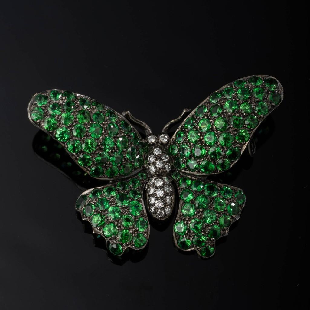 Garnet & Diamond Butterfly Brooch.: 18k gold, black rhodium finish, 4.08ct Tsavorite garnet, .20ctw diamond, 7.4 grams. Diamond embedded body, Tsavorite garnet embedded wings. Detailed condition reports are available upon requ