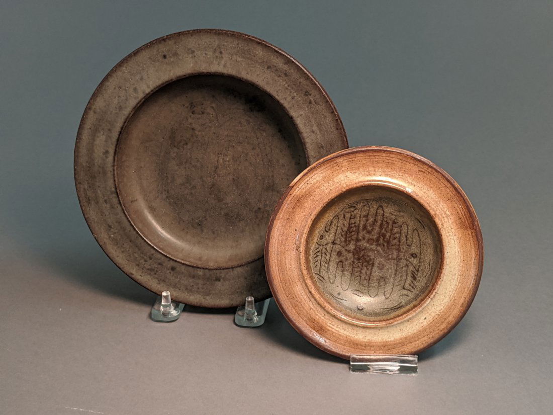 Two Edwin & Mary Scheier Art Pottery Bowls: Both matte finish, the larger with face design, the smaller with squiggle design. Diameters 7 1/4 and 5 1/4 inches.