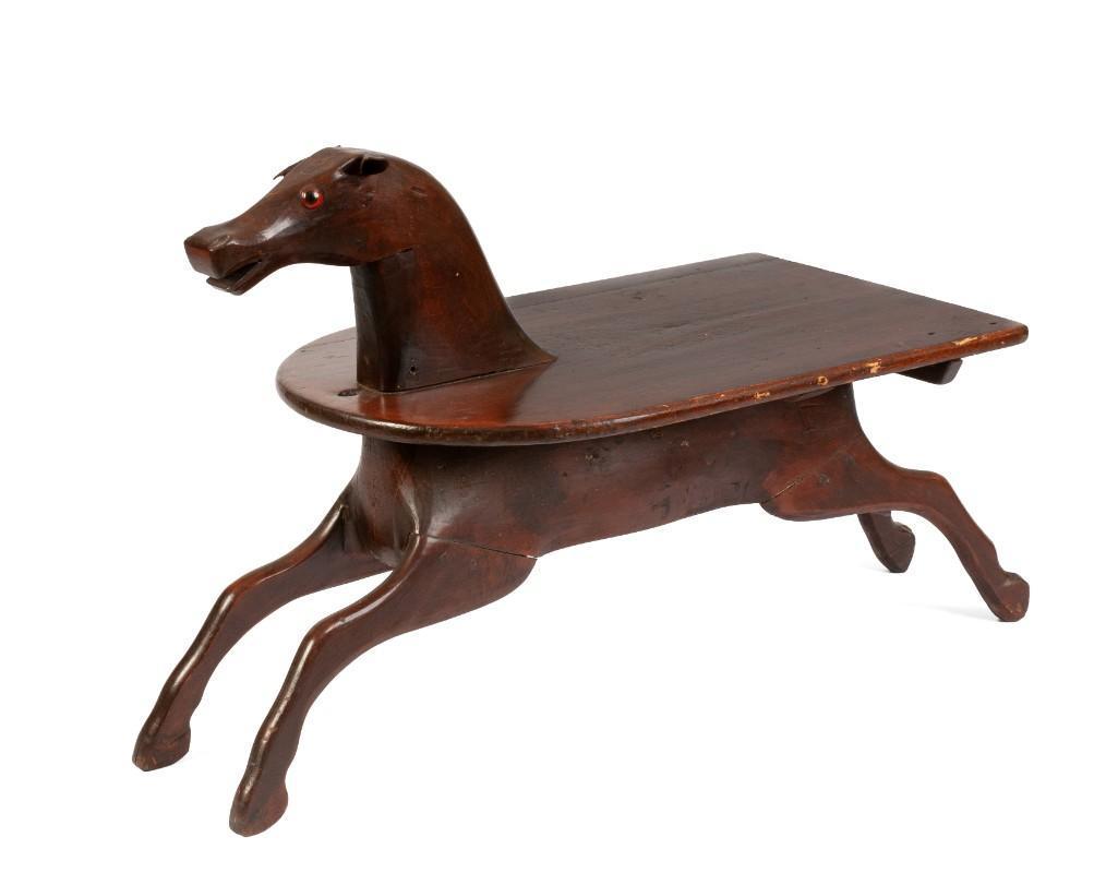 Early Rocking Horse Coffee Table.: Nineteenth century rocking horse, rockers removed and fitted as a coffee table. Length 38 inches, height 25 inches, depth of table top 18 inches.