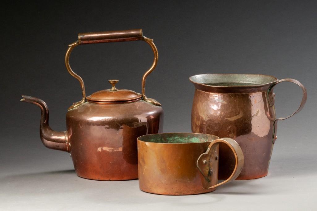 Three Copper Wares.: A tea kettle, height over handle 11 inches, dovetailed construction, a pitcher, height 7 inches, dovetailed construction, and a scoop, height 3 1/2 inches, dovetailed construction.