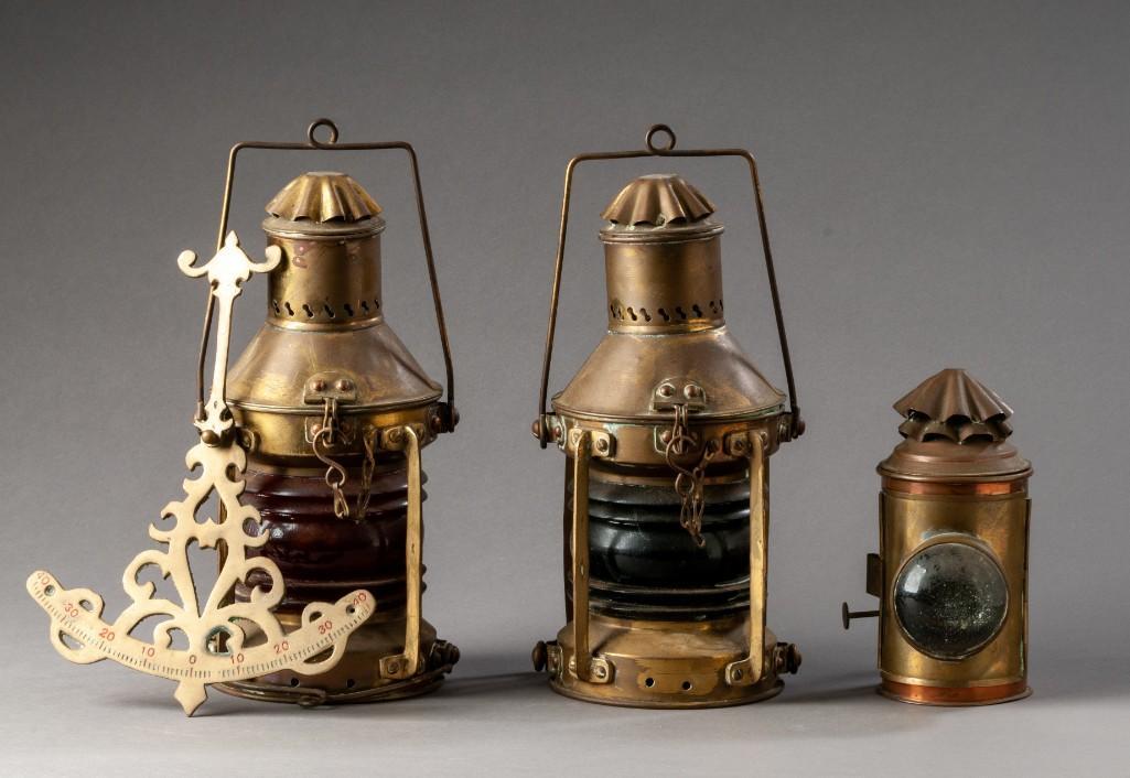 Pair of Brass Ship's Lanterns.: Port and starboard, height 12 inches. Unmarked. Together with a small handheld lantern, height 7 1/2 inches, and a brass inclinometer, height 6 3/4 inches.