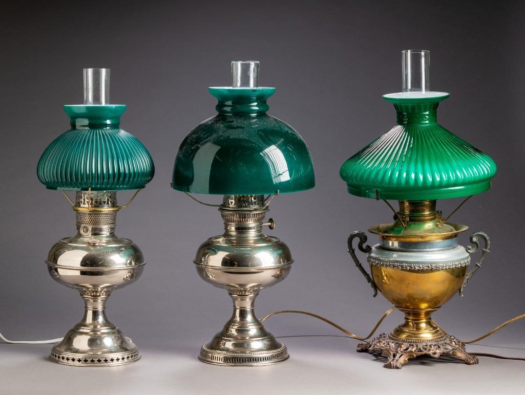Three Nickel Plated Brass Oil Lamps.: One by Rayo, overall height 20 inches. One by B&H, overall height 20 inches, and one by Aladin, height 21 inches. Each with green glass shade.