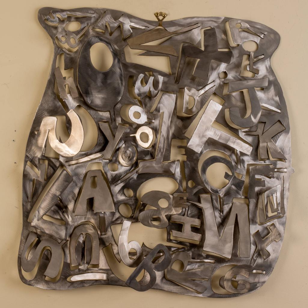 Brad Howe. Plasma Cut Metal Wall Art.: Various letters cut from a sheet of brushed steel. 27 x 27 x 3 inches.