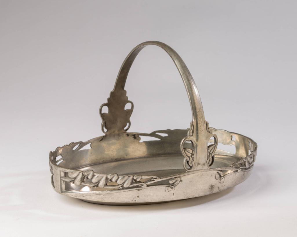 English Pewter Oval Basket: Archibald Knox design, no. 0359, height over handle 6.5 inches.