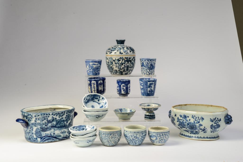 Large Group Blue and White Porcelain Items: Soup tureen with foo dog handles, width 11 inches, missing lid. Assorted tea cups, tea bowls, lidded cannister, and a jardiniere. 
