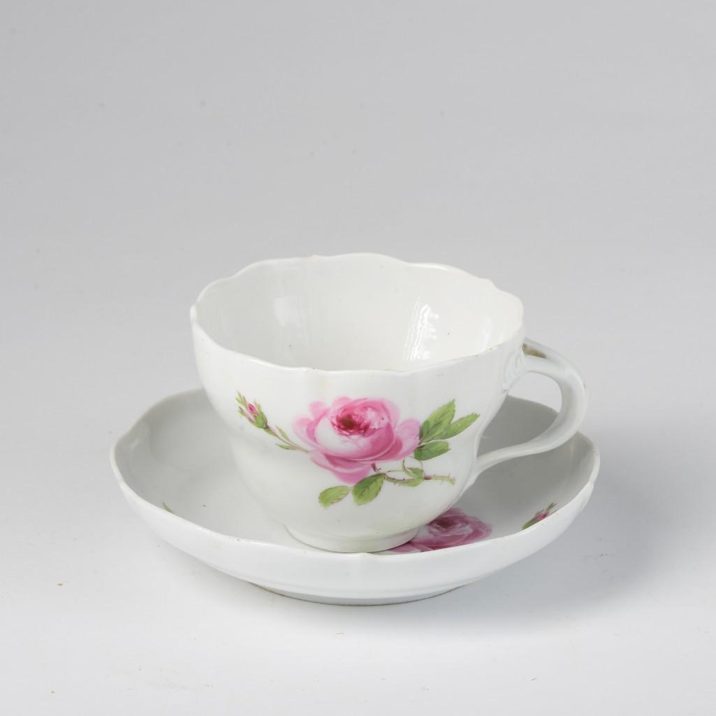 Meissen Porcelain Teacup and Saucer.: Rose pattern, diameter of saucer 6 inches. Chip to rim of saucer and rim of cup.