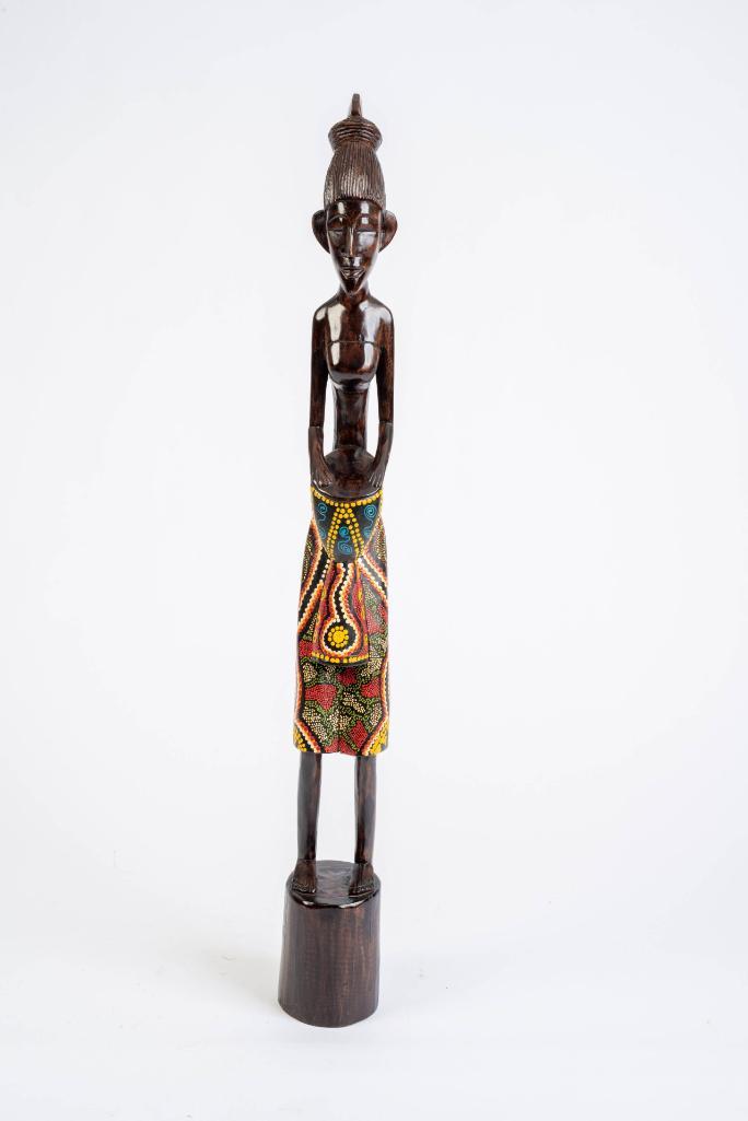African Carved Wood Sculpture of a Woman.: Depicted playing a drum, with multi-colored painted skirt. Height 39 inches