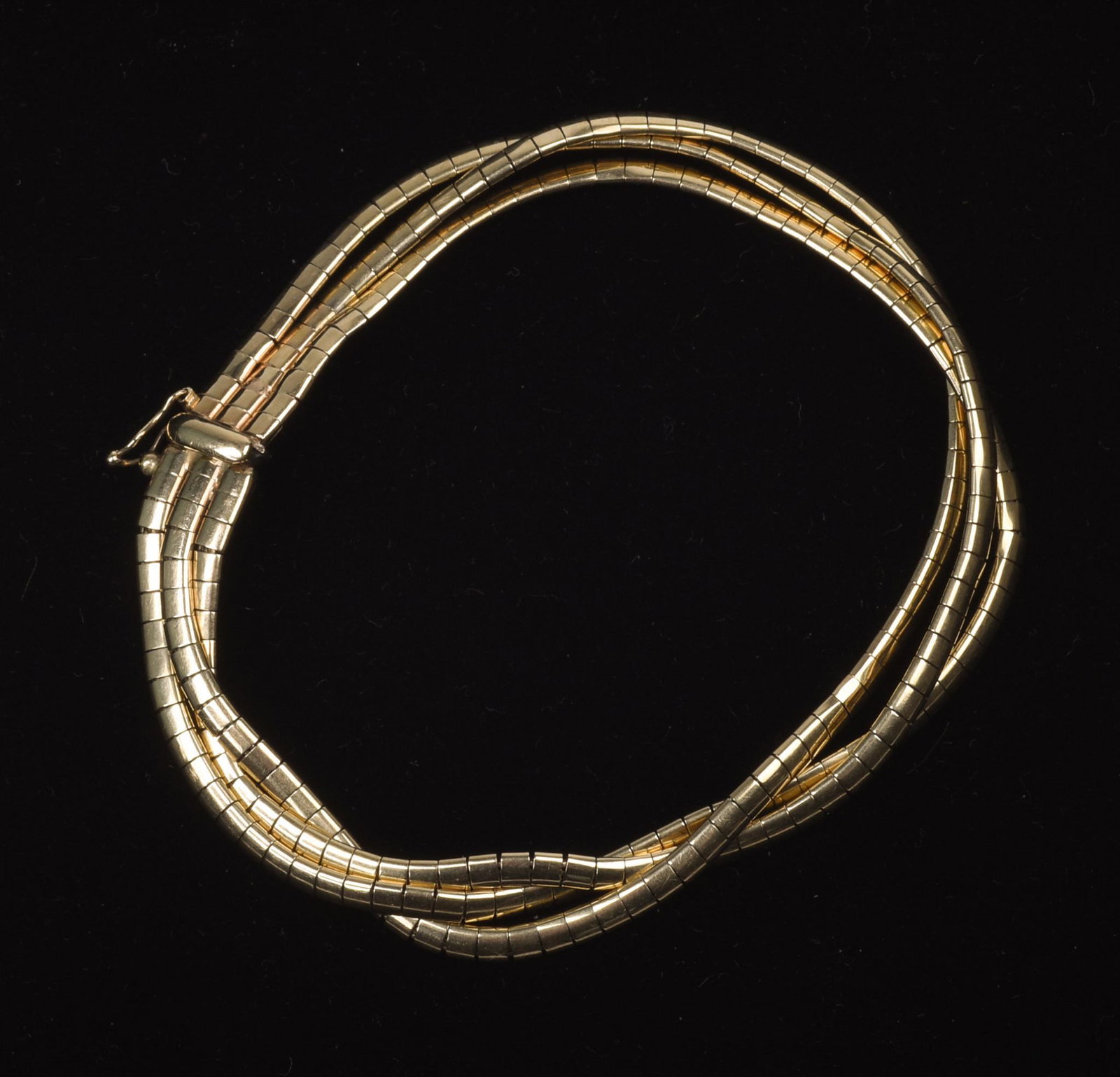 14K Yellow Gold Woven Omega Bracelet.: Three woven omega strands each approximately 2.7mm width. Length 7 inches, 18.8 grams.
