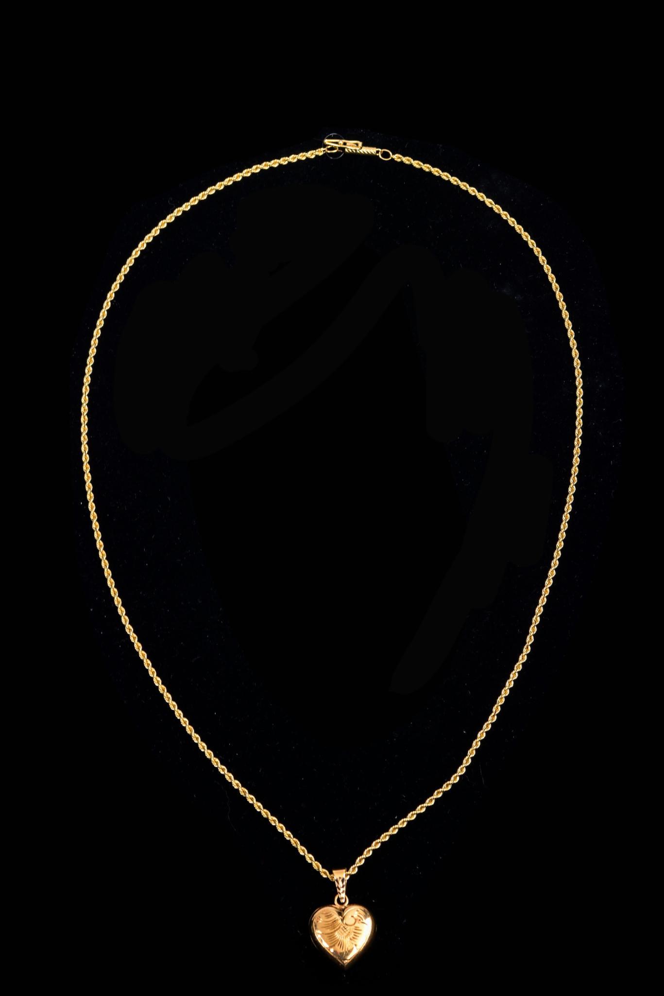 14K Yellow Gold Puffed Heart Locket.: With etched design. In a closed position, the heart measures approximately 20.3 x 17 mm, excluding bail. With a 14K gold chain, length 19 inches. Total weight 12 grams.