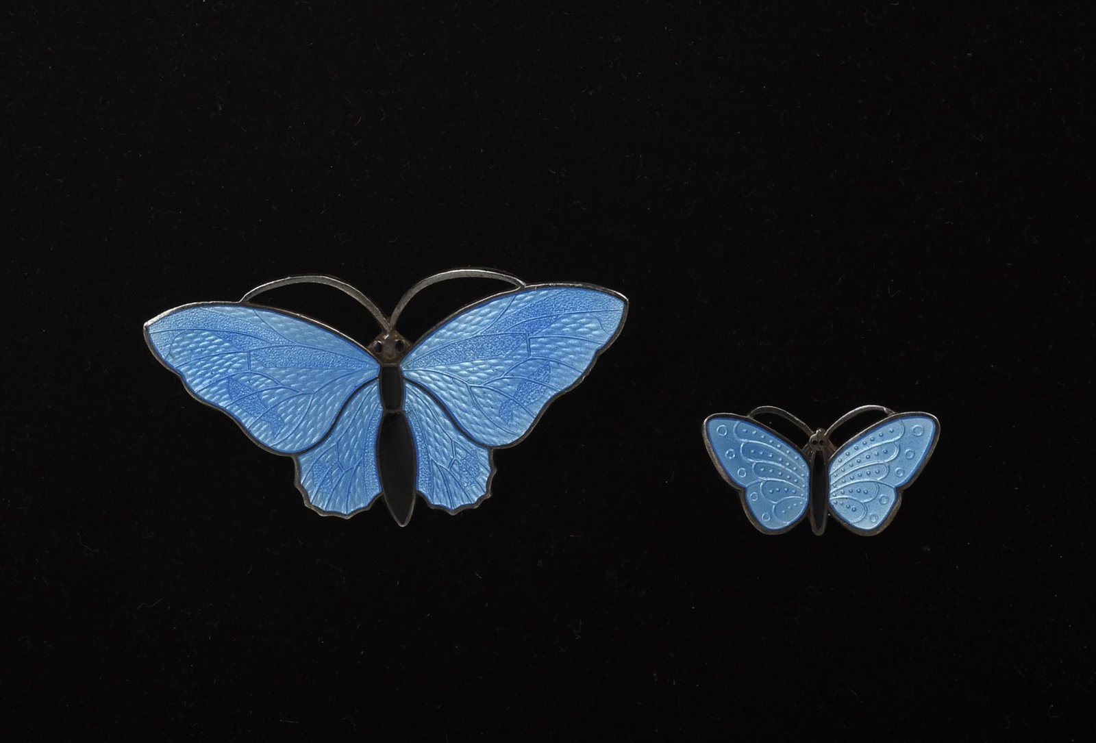 Two Sterling and Enamel Blue Butterfly Pins.: Both marked 925 s. Larger pin 2 inches by 1 inch. Smaller pin 1 inch by .5 inch.