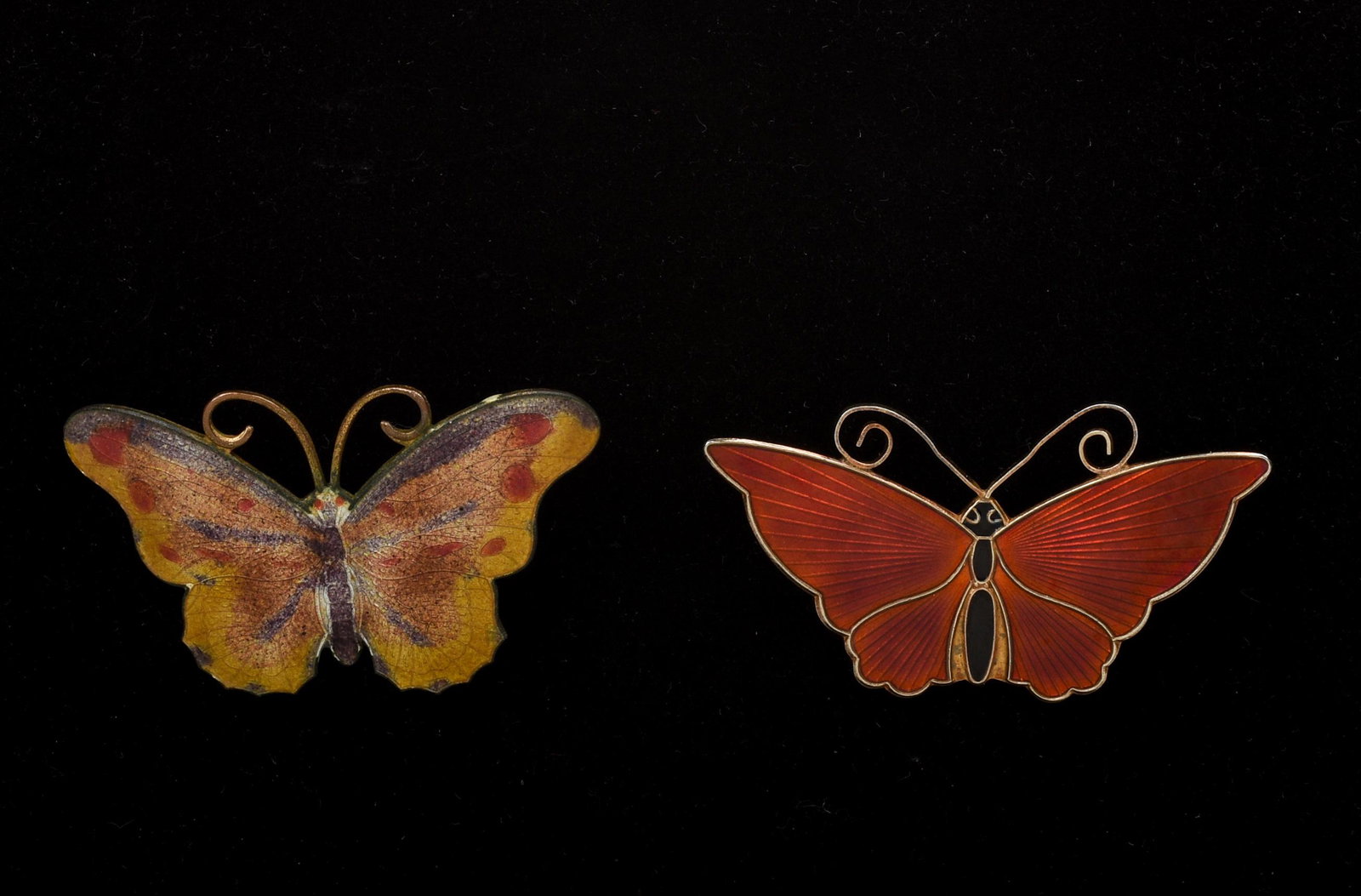 Two Enamel Butterfly Pins.: One sterling and red. The other multicolor enamel. Dimensions of multicolor butterfly 2 inches by 1.25 inches. Red one marked DA, 925 s, Norway-Sterling. Dimension of red butterfly 2.25 inches by 1.12