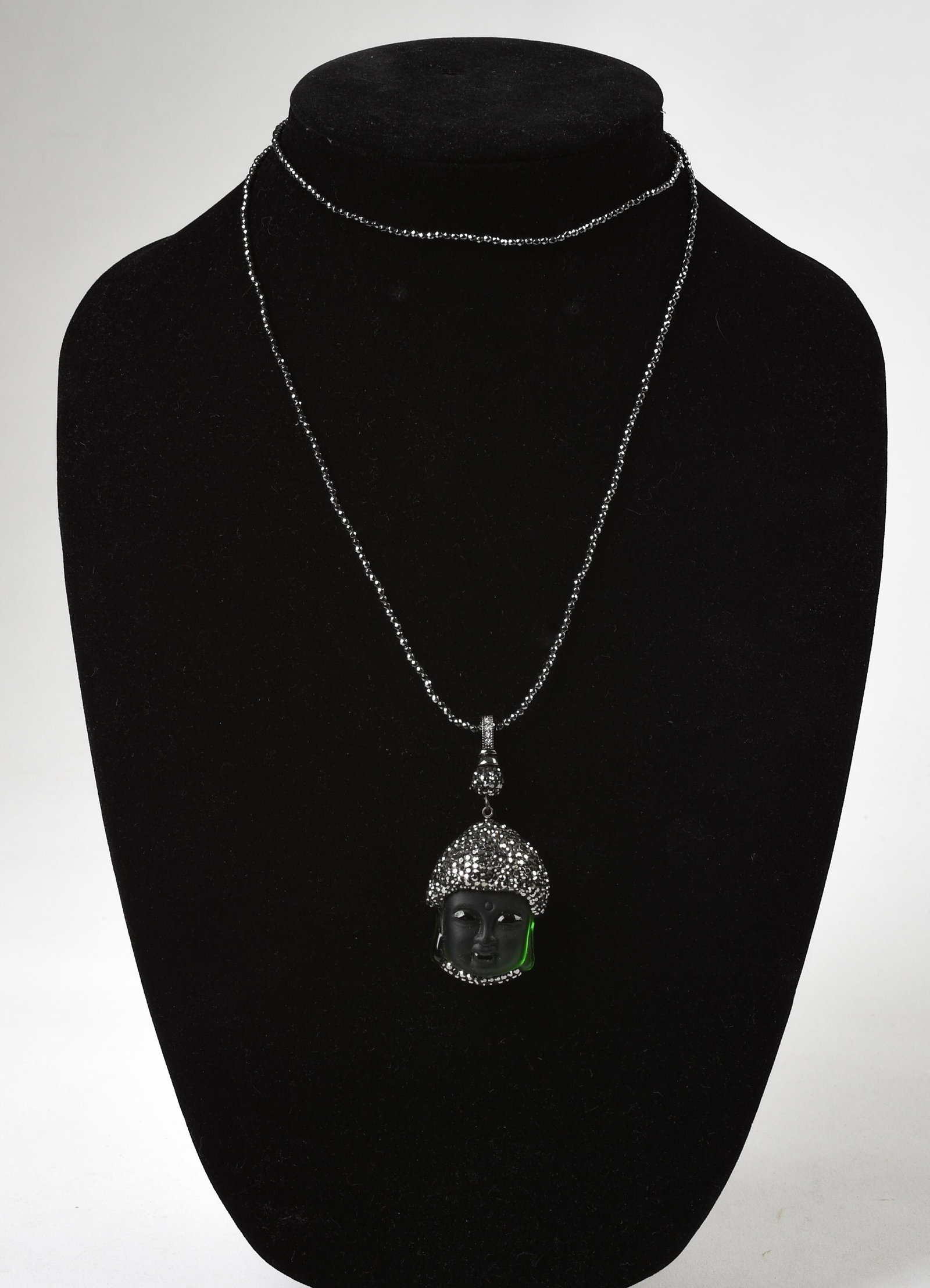 Carved Glass Buddha Head Necklace.: With cut steel. Length 30 inches.