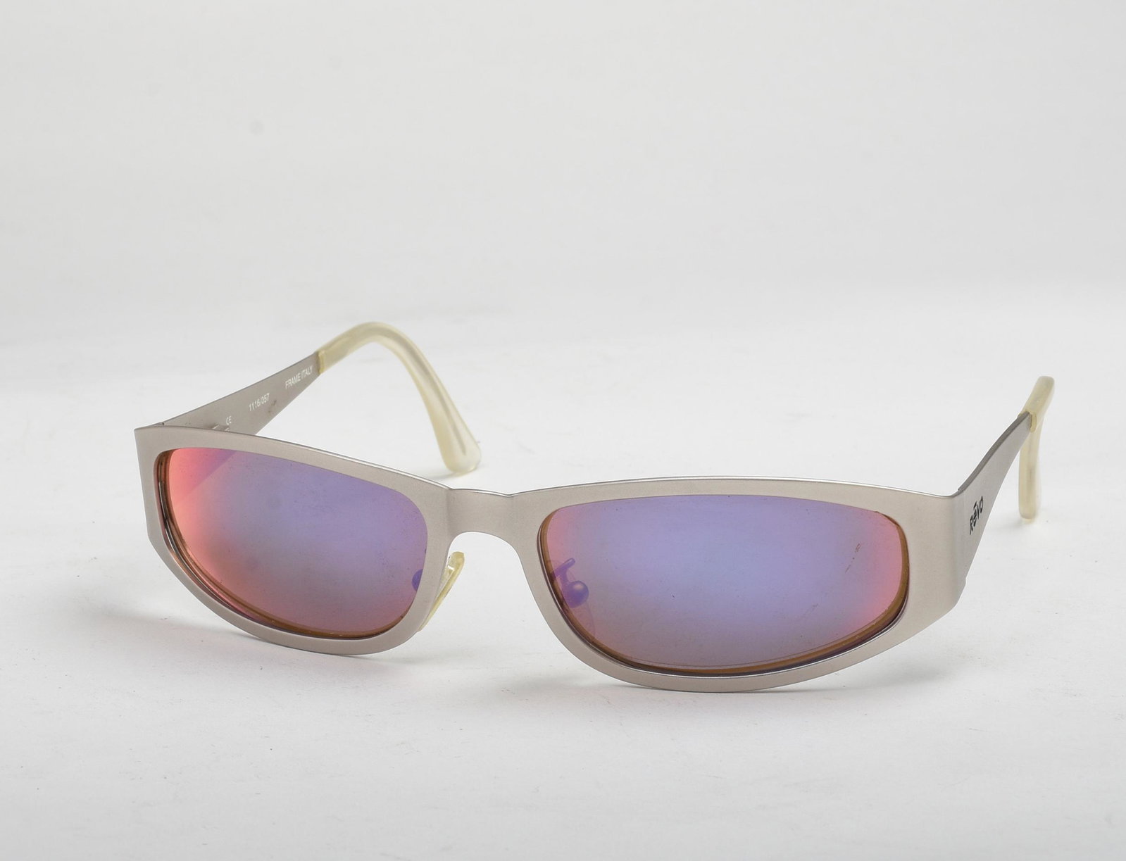 Pair of Revo Matte Silver Sunglasses.: With amber colored lenses.
