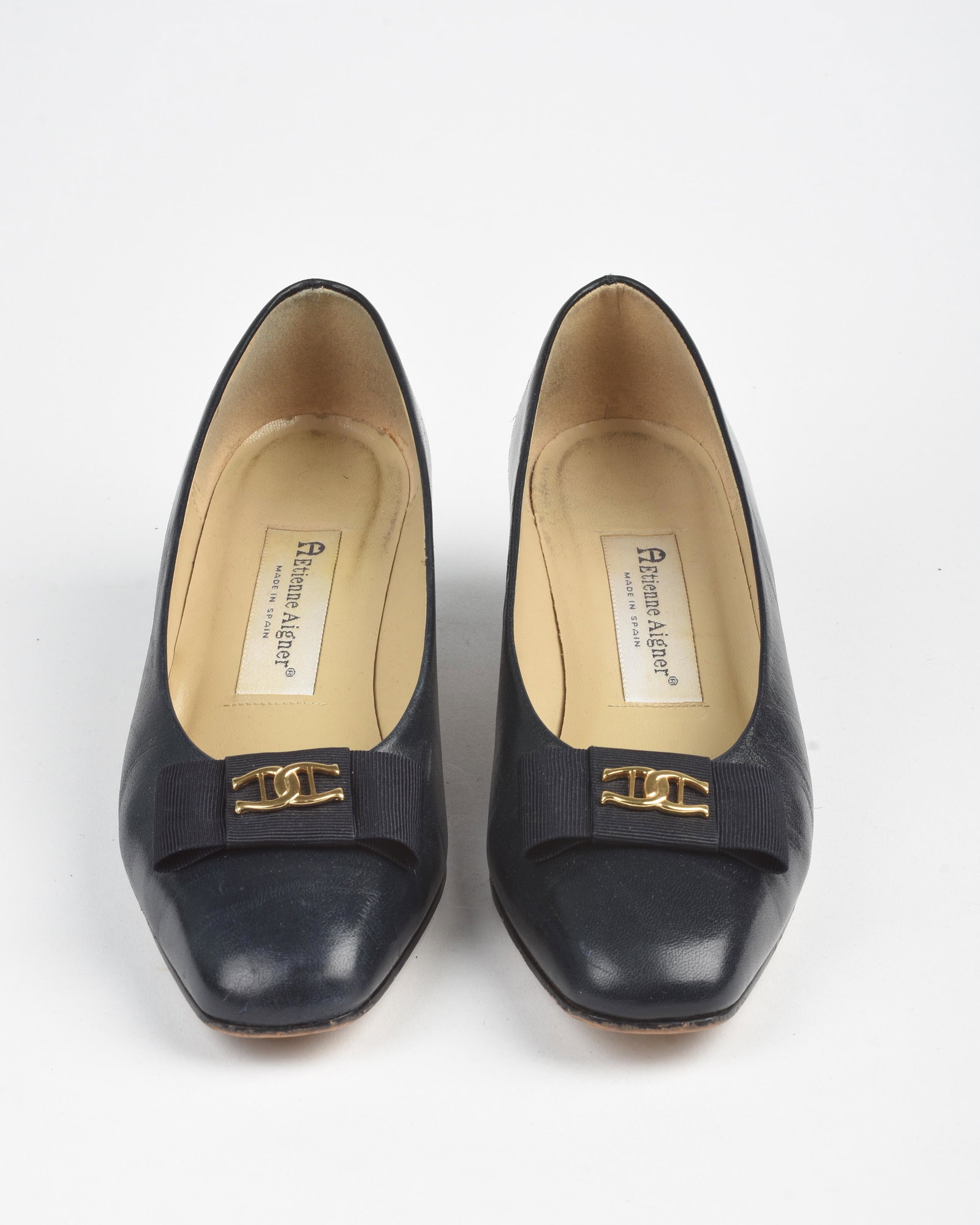 Pair of Etienne Aigner Navy Leather Pumps.: With bows. Size 7.5 medium. Condition: some wear.
