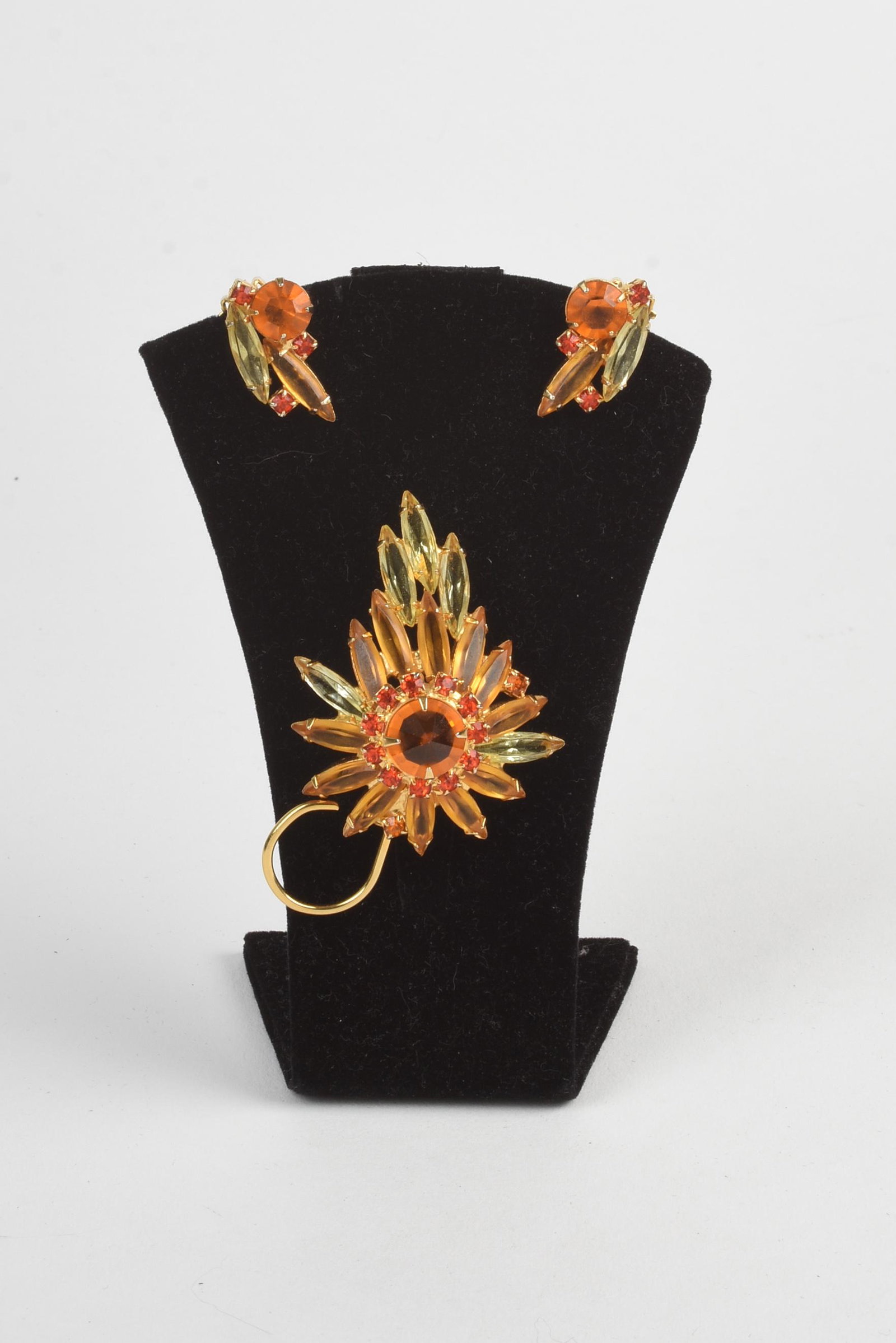 1950s Costume Jewelry Set.: Glass stone earrings and pin. Pin 2.5 inches by 2 inches. Earring length 1 inch.