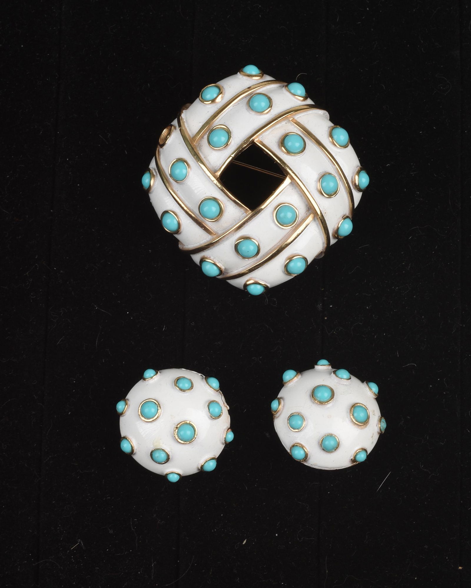 Trifari White Enamel and Faux Turquoise Brooch and: Brooch 2.25 inches diameter. Earrings 1 inch diameter. Condition: earrings in perfect condition. One stone missing from brooch.