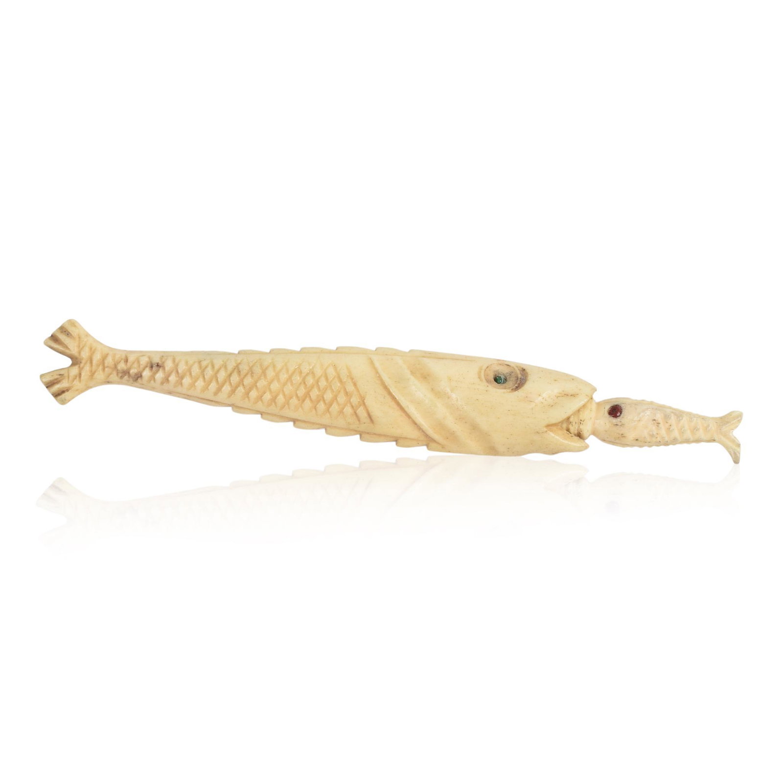 Carved Bone Needle Case.: In the form of a large fish swallowing a smaller fish, length 3.3 inches.