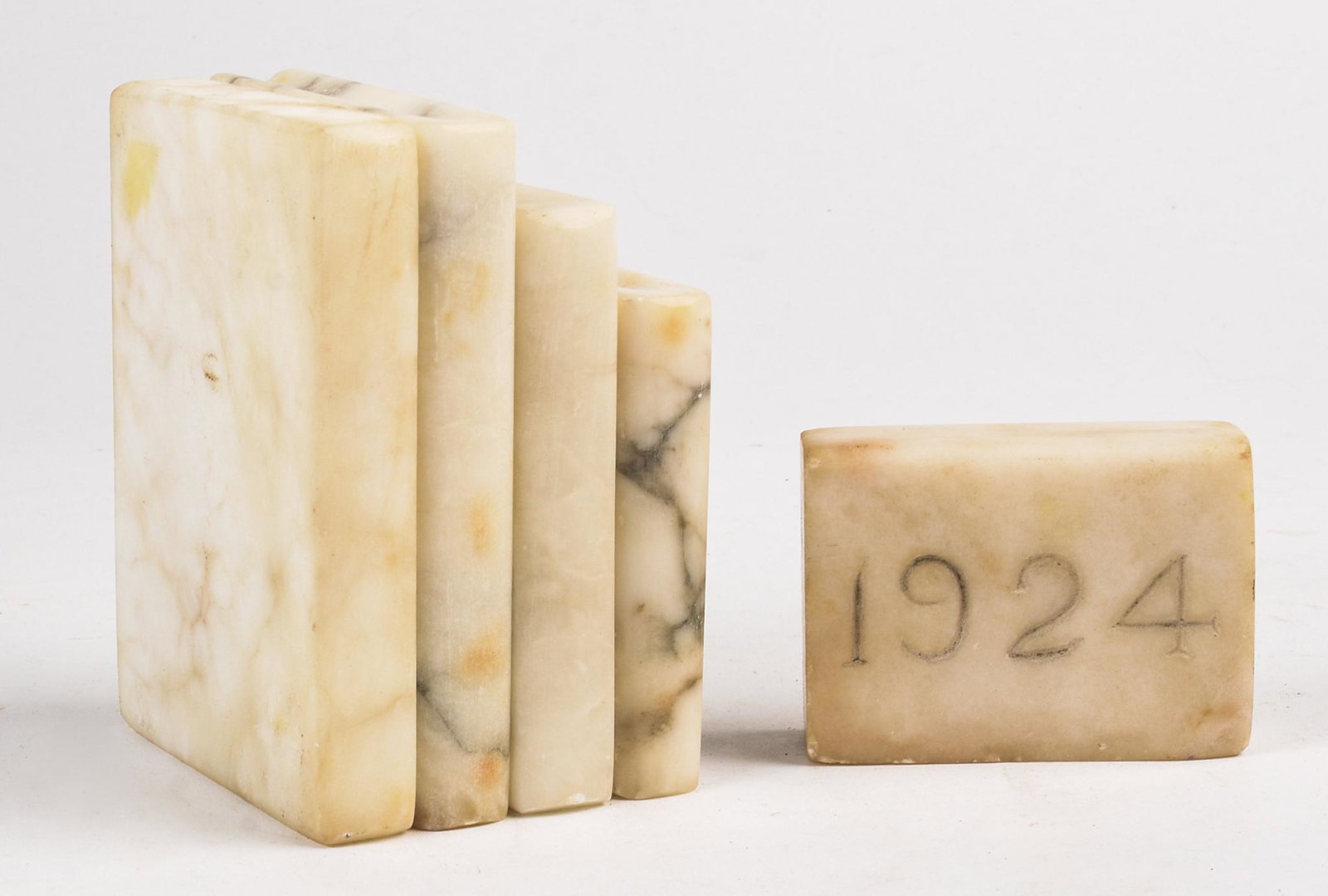 Four Carved Marble Books.: The largest, 4.375 x 3.25 inches. Together with a marble square inscribed 1924.
