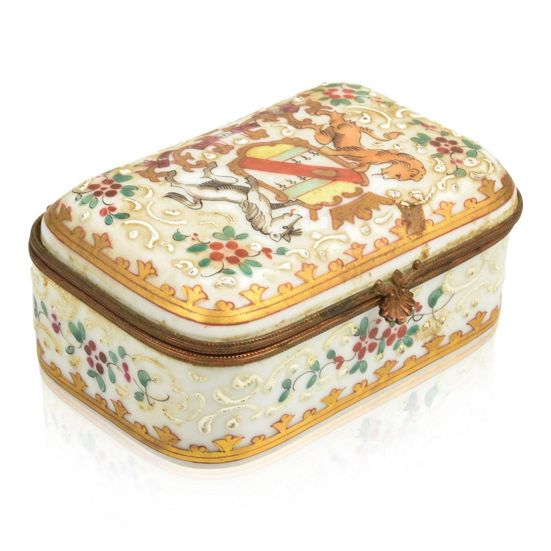 French Porcelain Armorial Jewel Casket.: Possibly Edmé Samson et Cie, Second Half Nineteenth Century. The cover painted in enamels with a Continental armorial flanked by lion and horse supporters, surrounded by bianco-sopra-bianco scr