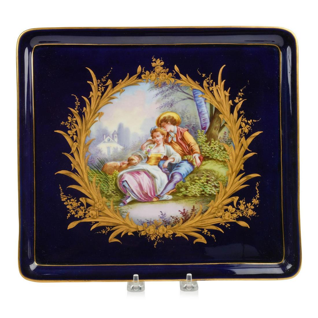 Sevres Style Hand Painted Porcelain Tray: 10.5 x 12 inches, depicting a pastoral scene in gilt floral frame on cobalt ground, artist signed Delaitre, Sevres mark on back, late 19th c.
