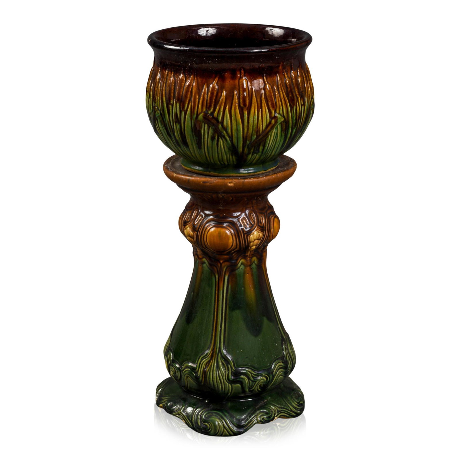 RRPCO Cattail Majolica Jardiniere.: Height 7 inches, diameter 9.5 inches, with associated pedestal, height 15.5 inches. Chip to base of pedestal.