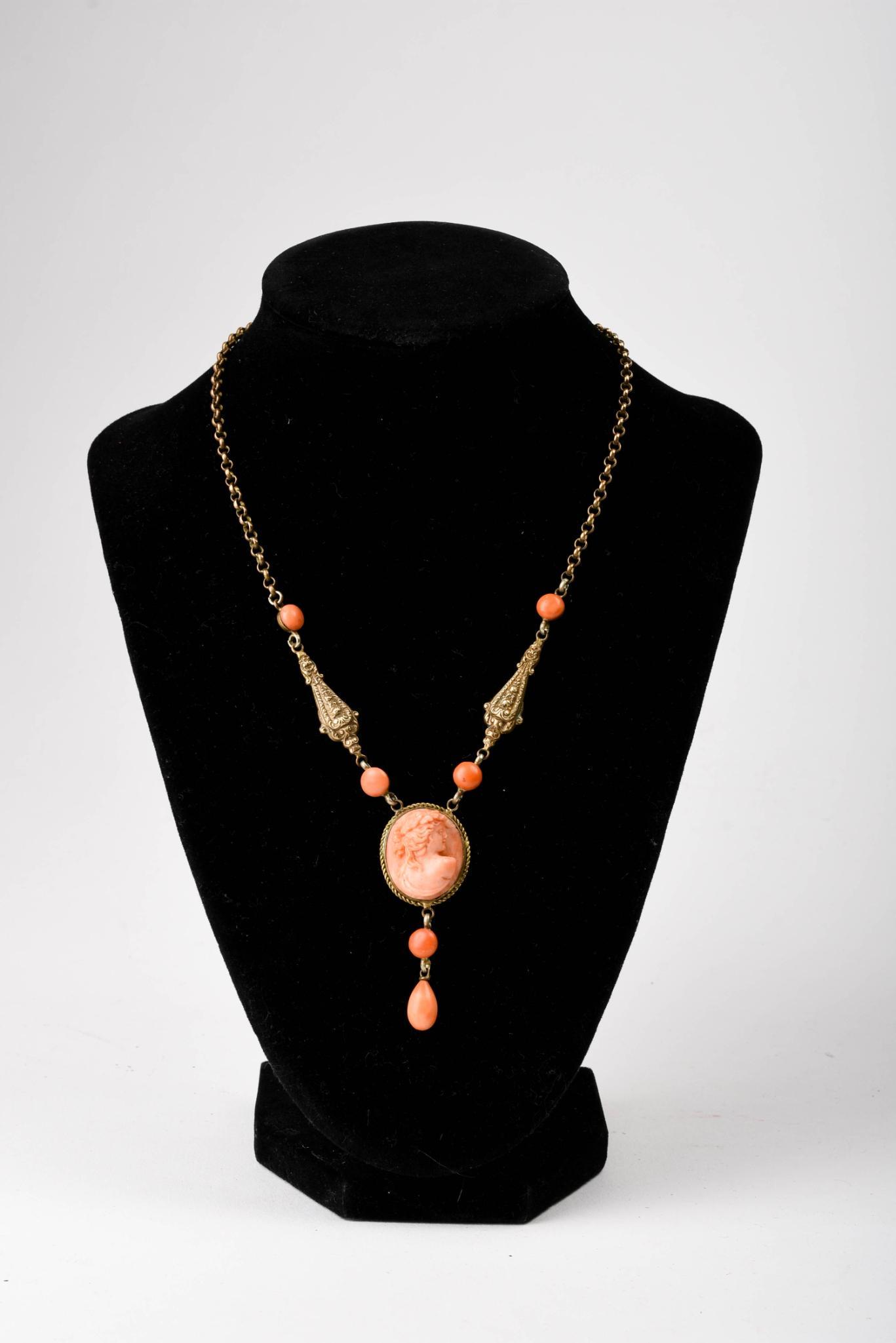 Carved Coral Cameo Necklace: Cameo 1 x .75 inches, chain 14 inches.