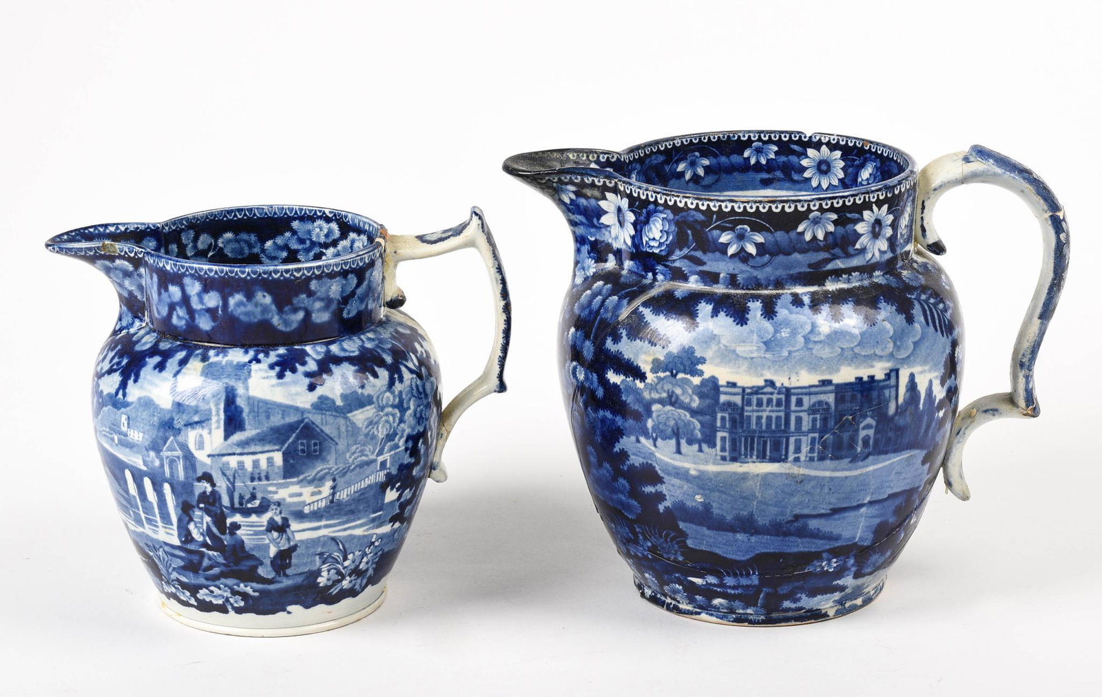 Two Blue Staffordshire Pitchers.: Heights 8 and 7 inches, each with repairs and chips.