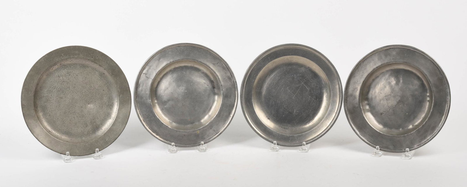 Four English Pewter Plates.: Late 18th and early 19th century, diameters 7.875 and 8.375 inches.