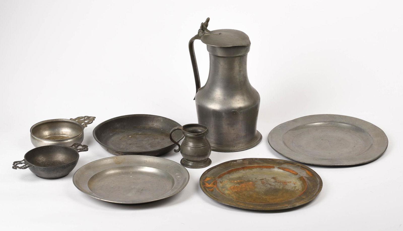 Collection of Pewter Items.: Lidded flagon, height 10.5 inches, 3 plates, low bowl, two porringers, and a gil measure.