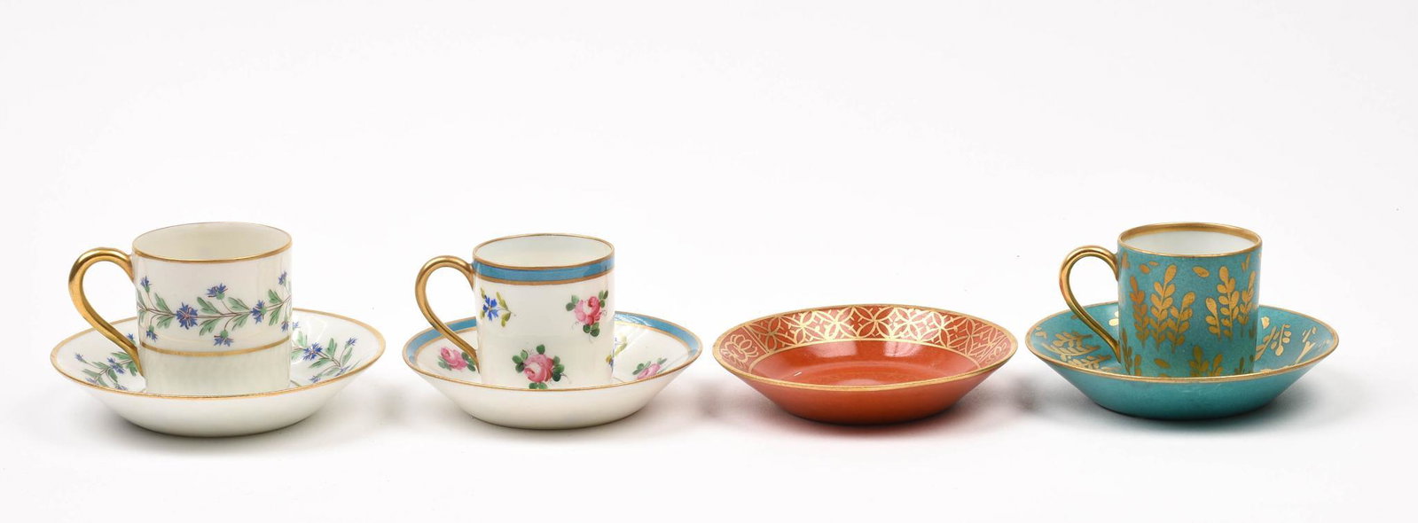 Three French Limoges Teacups and Saucers.: Teal and gilt with deer, diameter of saucer 4 inches, and two floral design cups and saucers. Together with a fourth saucer.