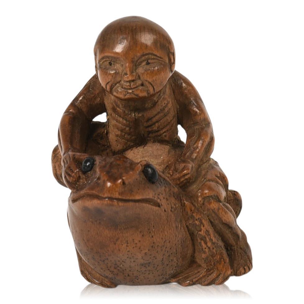 Japanese Carved Wood Netsuke of a Man Astride Frog: 19th c., height 1.5 inches.