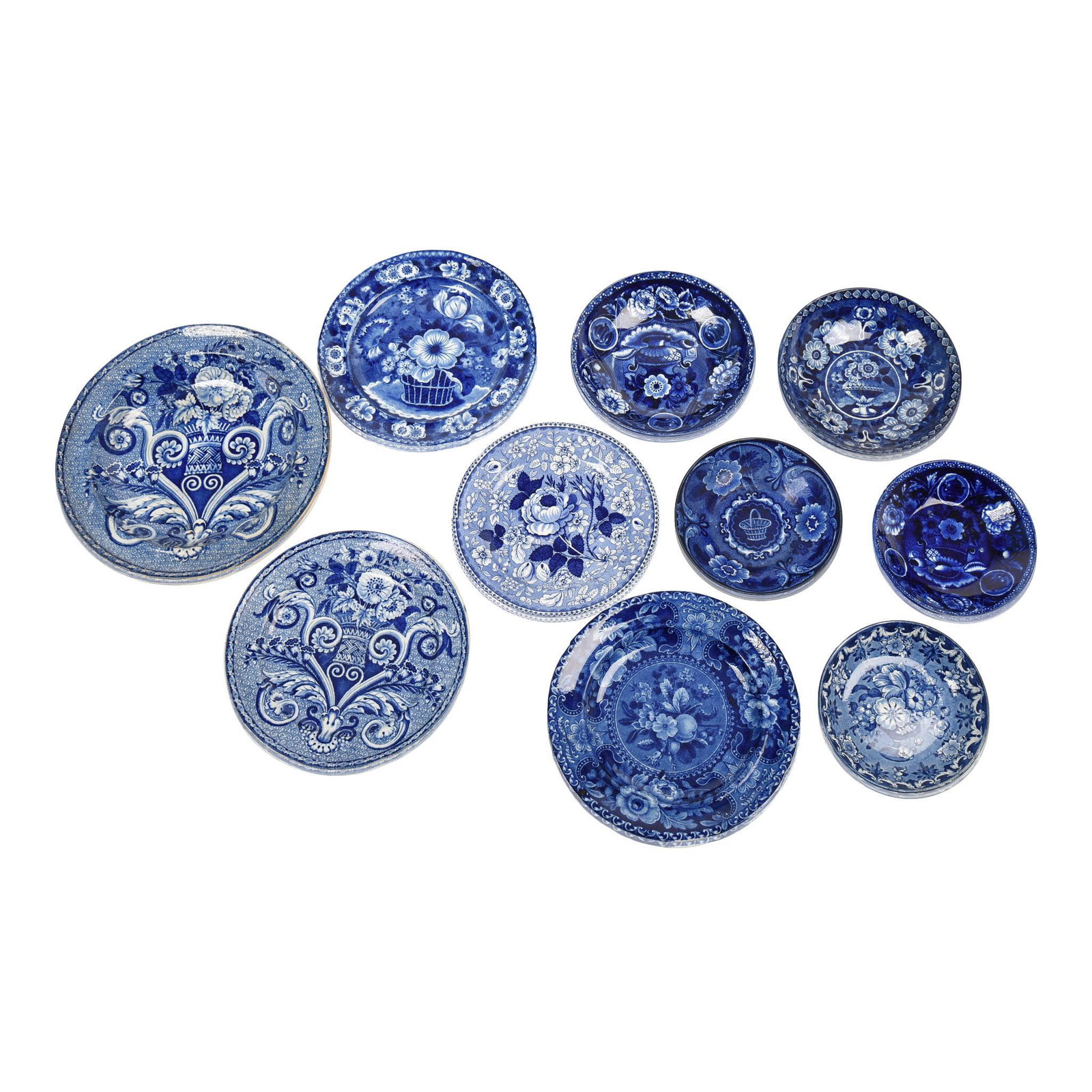 Ten Staffordshire Blue Transfer-Printed Saucers &: Various makers, 1810-50. Including one 'Basket' plate, and a soup plate and plate, each printed with a scroll and flower vase device, all James & Ralph Clews, 1814-34, printed and impresse